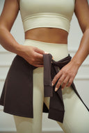 Women's tie-waist cover-up skirt worn over leggings, front view on model — DWEGO